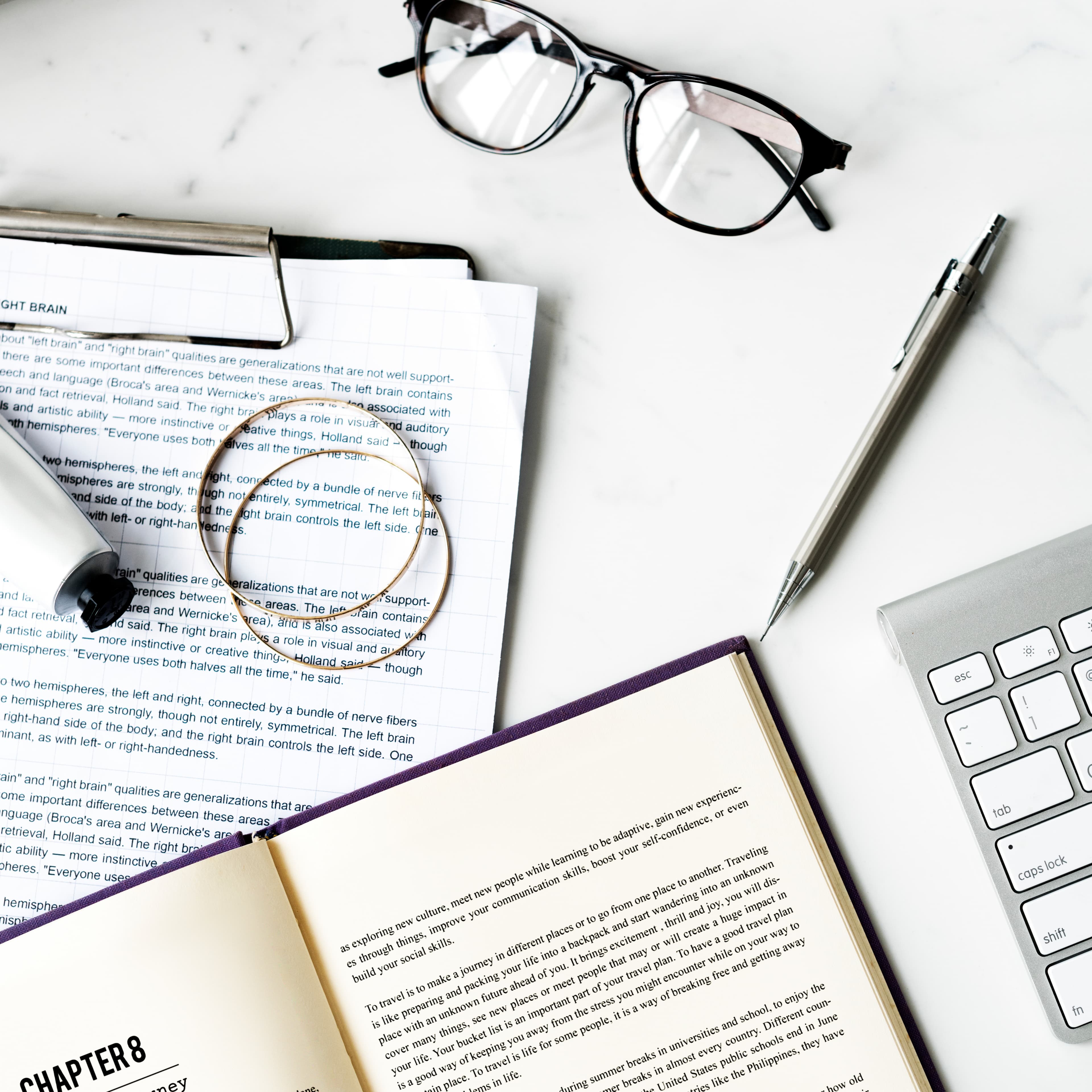 Open notebook and research materials on a desk